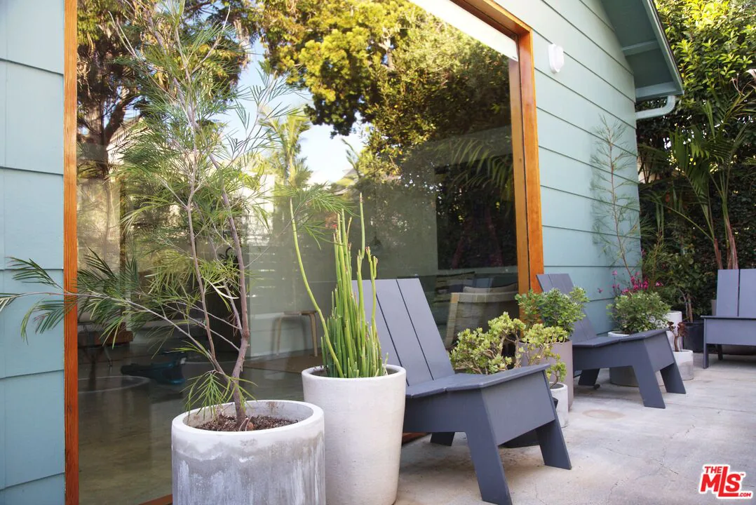 745 Navy Street — living area with open plywood ceilings opening to the garden