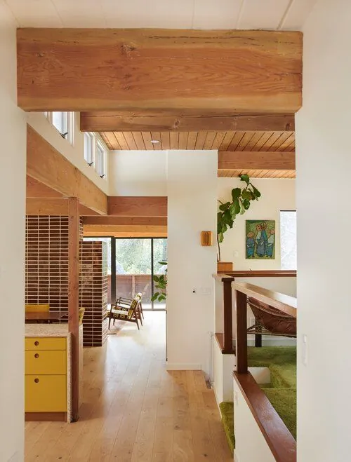 Exposed timber beam entry hallway in a Brentwood mid-century estate