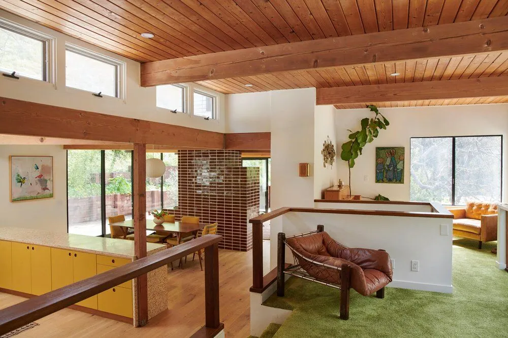 Mid-century modern split-level living room in Brentwood with wood-paneled ceilings and clerestory windows