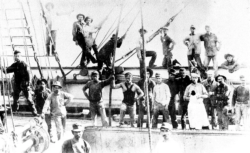 Workers and sailors posed on the Long Wharf structure at Port Los Angeles, Santa Monica, 1890s