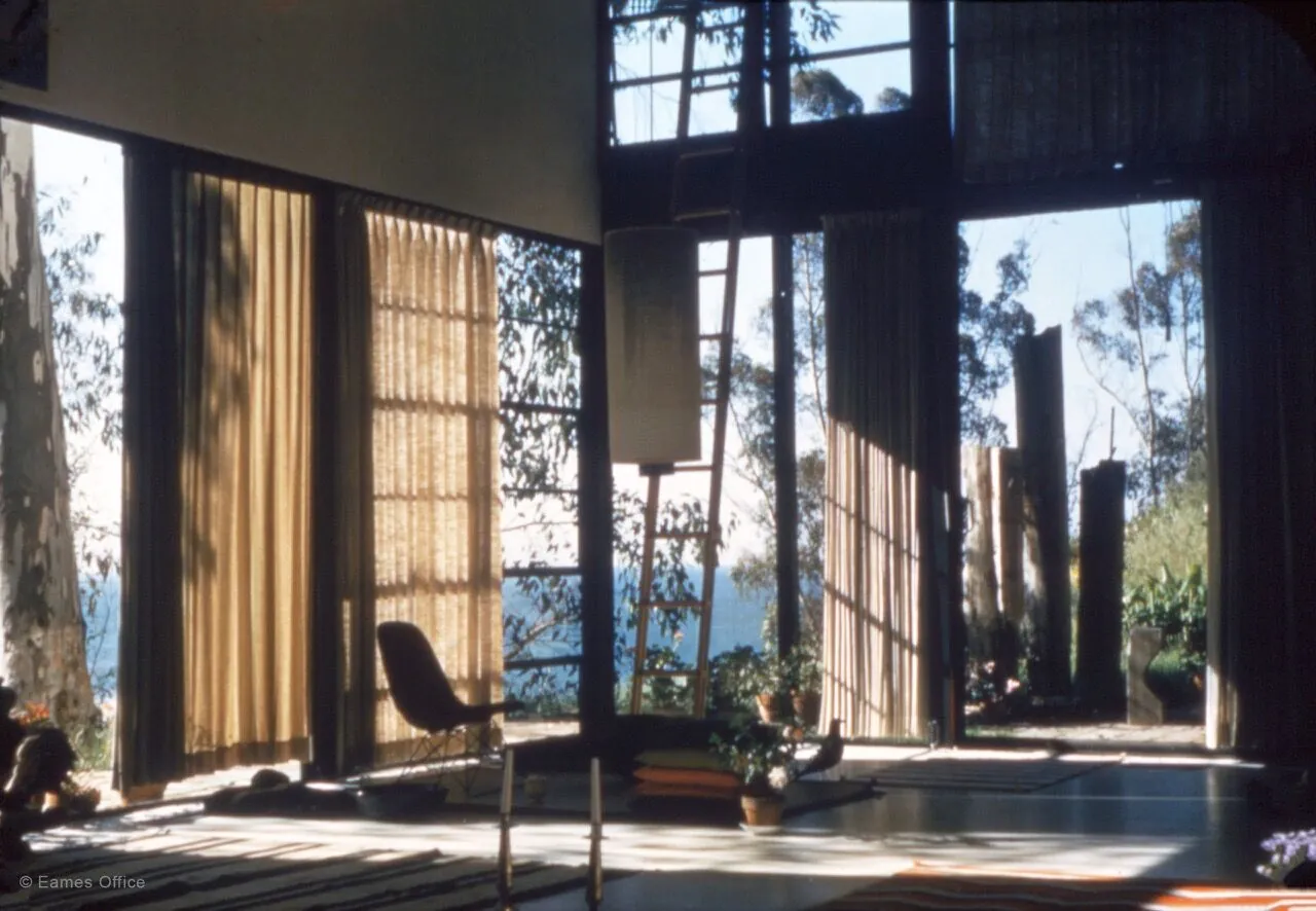 Interior of the Eames House (Case Study House #8) with floor-to-ceiling curtain walls and eucalyptus views