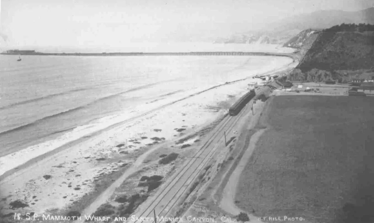 Aerial view of the Long Wharf extending into Santa Monica Bay north of Rustic Canyon, 1890s