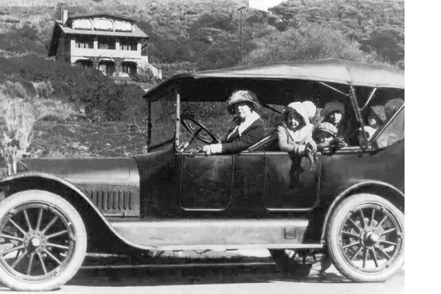 Early canyon family in their automobile with a hillside home in the background, Santa Monica Canyon 1910s