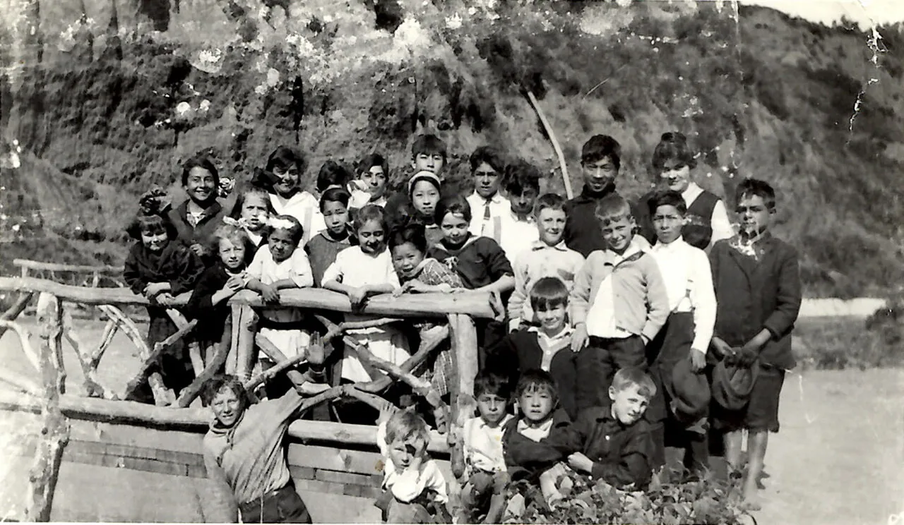Group of canyon schoolchildren gathered on a wooden fence, early 1900s Santa Monica Canyon