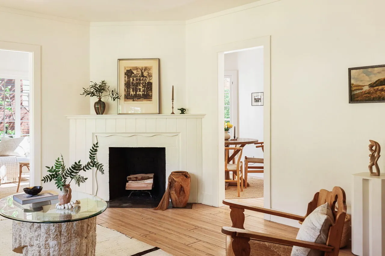 Living room with white mantel fireplace and handcrafted wood furniture in a Santa Monica Canyon cottage