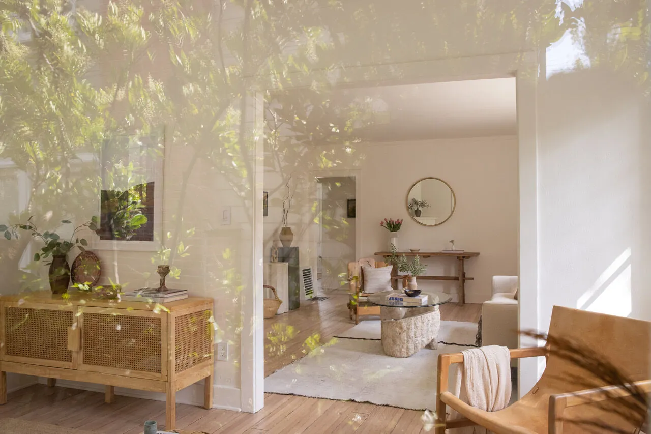 Sun-dappled living room seen through canyon foliage in a Santa Monica Canyon home