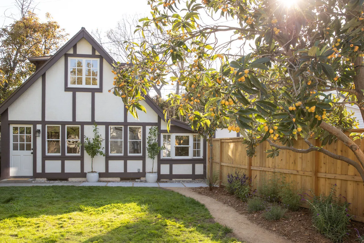 Tudor-style cottage at golden hour on a tree-lined Santa Monica Canyon street